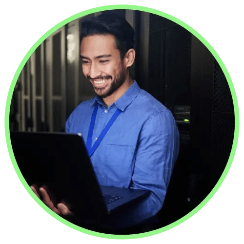 Man-holding-a-laptop-in-a-dark-server-room